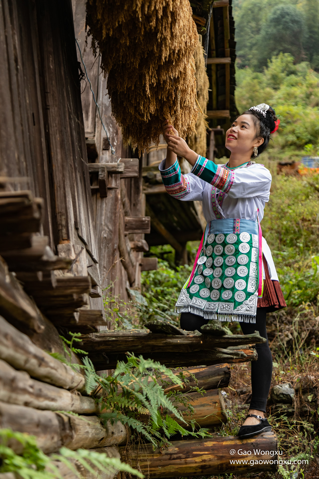 A Dong woman in Zhaoxing wearing traditional indigo costume and silver ornaments