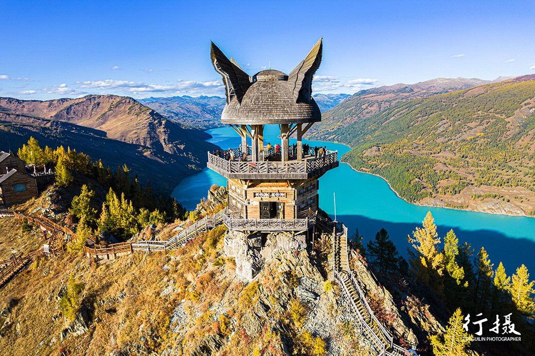 Kanas Lake seen from the Fish-Viewing Pavilion, turquoise water ringed by snow peaks