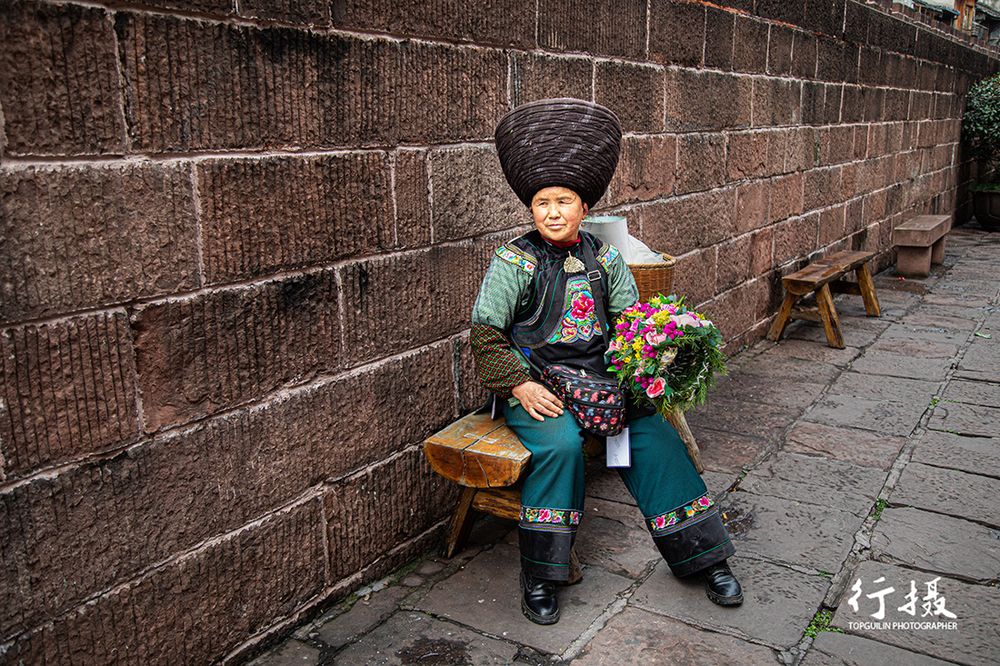 Miao woman in full embroidered festival costume with silver jewellery