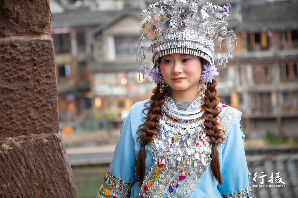 Close-up of a Miao woman's silver ceremonial headdress and embroidered collar